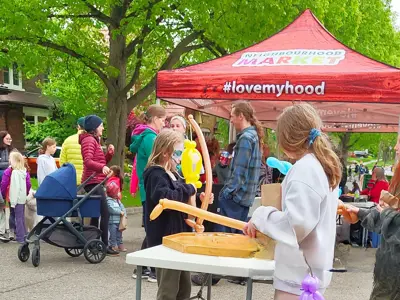 Girl standing at a table in front of a pop up canopy