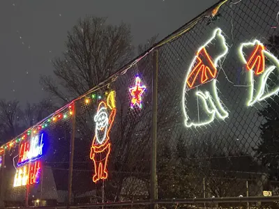 christmas light display on a fence in the winter