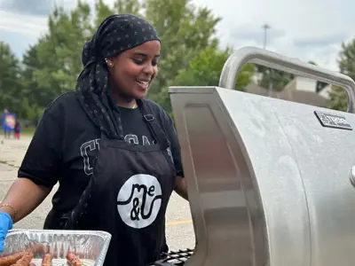 A teenage girl barbecuing food