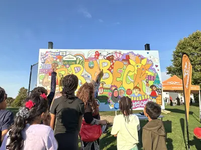 The back of kids looking at a street art